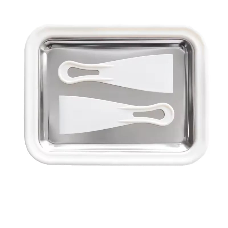 Rectangular metal tray with two white plastic tools on a white background